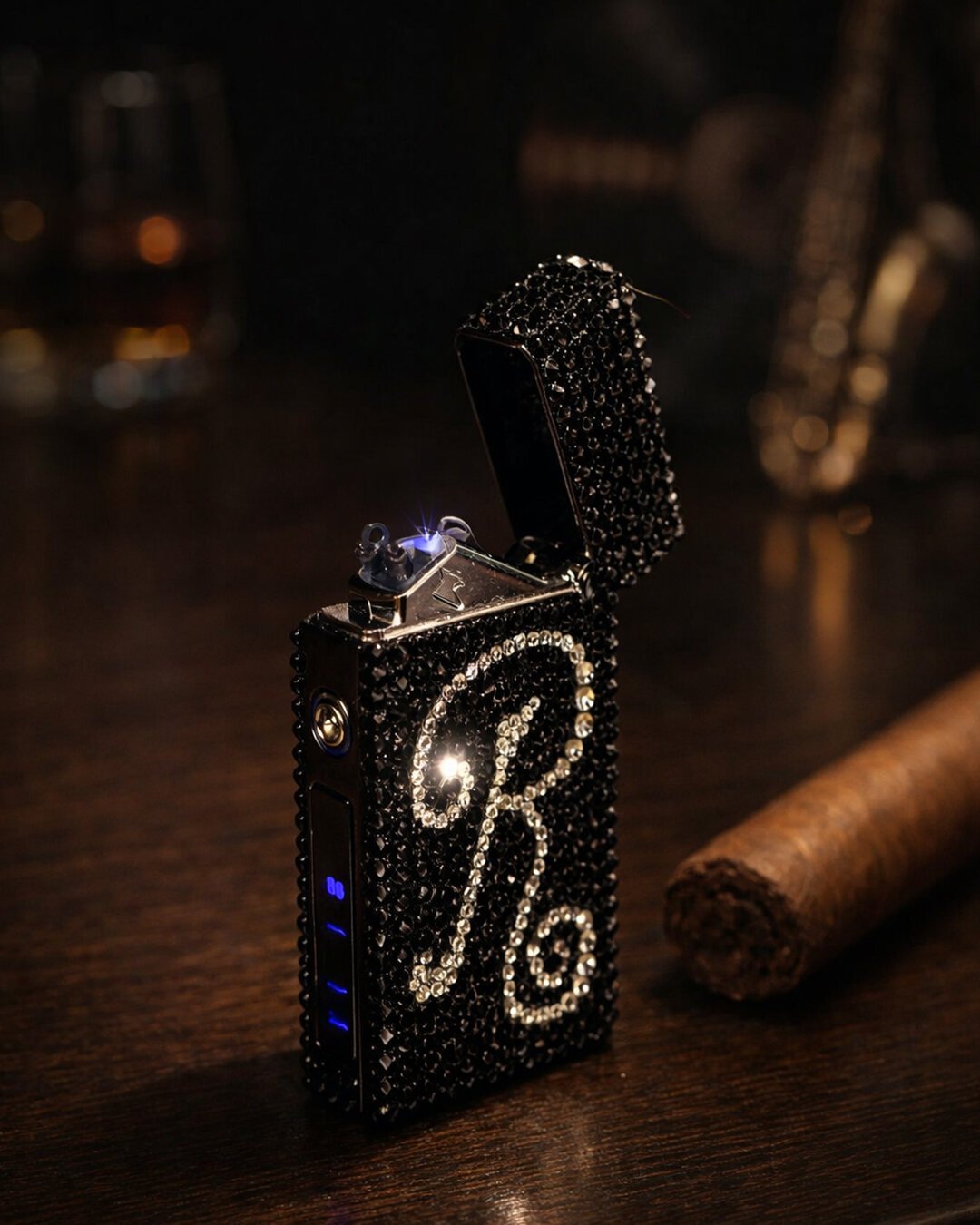 The same crystal lighter open and lit on dark wood beside a cigar